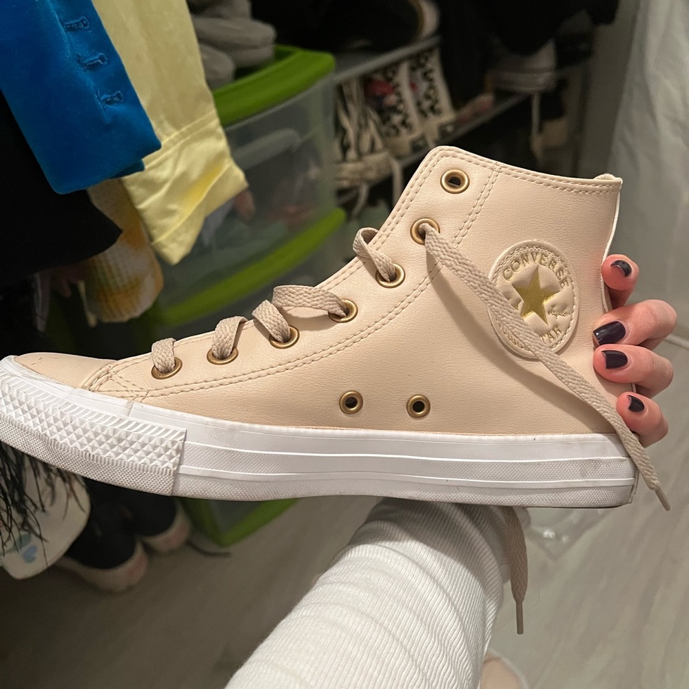 Slightly worn beige converse